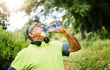 Image showing Senior man, fitness and drinking water in nature for hydration or natural sustainability after workout. Mature male person with mineral drink from exercise, training or cardio in recovery or break