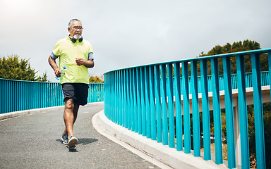 Image showing Senior man on bridge, speed walk for fitness and cardio, training or running with wellness and vitality. Runner in street, performance and challenge with exercise, health and workout in retirement