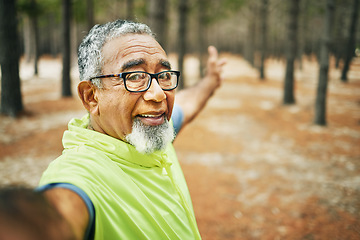 Image showing Selfie, excited and senior man hiking for health, wellness or cardio training on a mountain. Smile, nature and happy elderly male person taking a picture on cellphone for outdoor trekking in woods.