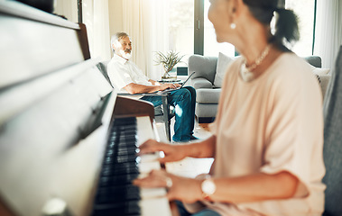 Image showing Senior woman playing piano for music in living room for bonding, entertainment or having fun. Happy, smile and elderly Asian female person with husband in retirement enjoying keyboard at modern home.