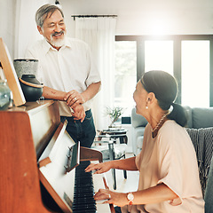 Image showing Elderly couple playing piano for music in living room for bonding, entertainment or having fun. Happy, smile and senior Asian man and woman in retirement enjoying keyboard instrument at modern home.