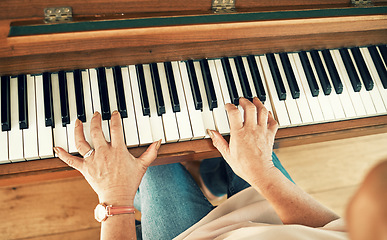 Image showing Hands, piano and senior woman playing for music in living room for musical entertainment practice. Instrument, hobby and elderly female person in retirement enjoying a song on keyboard at modern home