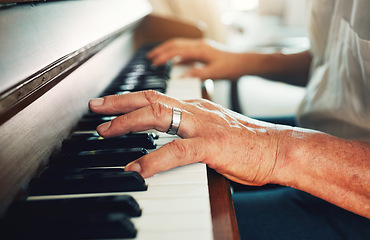 Image showing Hands, piano and senior man playing for music in living room for musical entertainment practice. Instrument, hobby and elderly male person in retirement enjoying a song on keyboard at modern home.