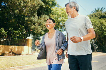 Image showing Running, mature couple and happy for fitness, exercise and workout in road of neighborhood. Asian man, woman and smile in street for healthy cardio wellness, performance and action together outdoor