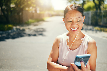 Image showing Phone, fitness and senior woman in road listening to music, playlist or album for running exercise. Happy, sports and elderly female athlete runner streaming song for cardio workout in outdoor street