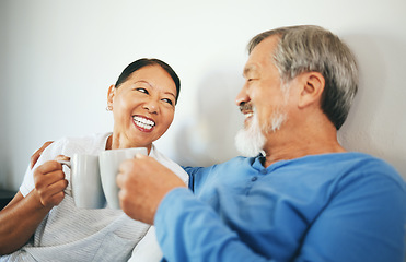 Image showing Senior, coffee or happy couple in bedroom at home bonding or talking in marriage together. Cheers, drinking morning tea or Asian woman laughing with a romantic old man in retirement to relax