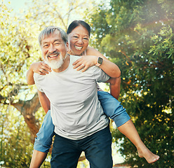 Image showing Piggy back, portrait and mature couple in garden for bonding, relationship and relaxing outdoors. Marriage, nature and senior Asian man and woman happy, laughing and playful for love, care and fun