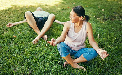 Image showing Happy couple, yoga and lotus meditation on grass at park for mindfulness, peace and calm. Mature man, funny woman and meditate in holistic exercise, wellness or zen to relax for body health outdoor