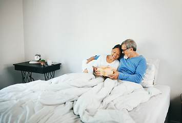 Image showing Happy couple in bed, mature or hug for gift for anniversary, care or love in home, house or retirement. Giving, Asian man or excited senior woman with birthday present box for romance in bedroom