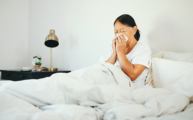 Image showing Senior woman, blowing nose and sick in bed with allergy, virus from bacteria with health and wellness at home. Sinus infection, medical condition with toilet paper for illness and sneezing in bedroom
