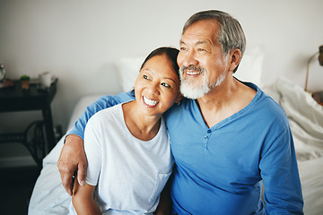 Image showing Senior, thinking or happy couple hug in house bedroom together to relax on holiday with bond or support. Embrace, lovers or romantic Asian man with a mature woman with love, smile or care in marriage