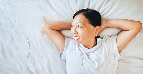Image showing Bed, thinking and happy mature woman sleeping, tired or nap for stress relief, morning wellness or retirement rest. Top view, mockup space and Japanese person relax, daydream or smile in home bedroom