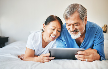 Image showing Mature couple, tablet and relax in bed for love, online shopping and streaming multimedia. Happy asian man, woman and search digital blog in bedroom for social network, subscription and download app