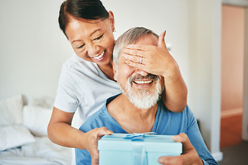 Image showing Old couple, surprise and woman with gift for man, cover eyes with celebration and happiness at home. Anniversary, birthday and marriage, giving present for special event and life, retirement and joy