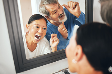 Image showing Old couple, flossing in mirror and dental in bathroom, hygiene and teeth whitening during morning routine at home. Fresh breath, orthodontics and reflection with thread, health and oral care