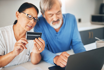 Image showing Mature couple, credit card and laptop for home online shopping, loan application or financial management in kitchen. Man and woman with computer for internet banking, security numbers or registration