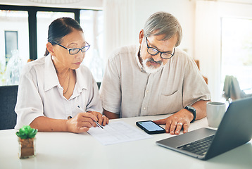 Image showing Senior couple, phone and finance in budget planning, invoice or documents together on table at home. Mature man and woman writing in financial plan, expenses or bills with paperwork on desk at house