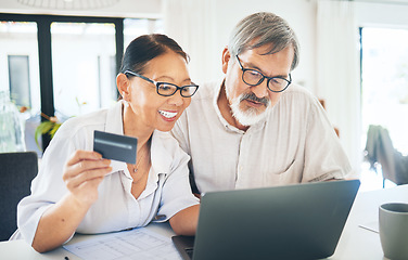 Image showing Mature couple, credit card and computer for home online shopping, loan application or digital money or finance in kitchen. Happy woman and man on laptop internet banking, easy payment or registration