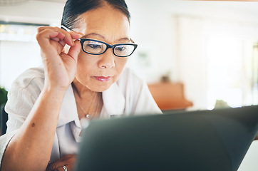 Image showing Mature woman, glasses and reading on laptop for blog or article on eye care, health and lens sale or discount. Business person with vision and computer in work from home job or optometry website