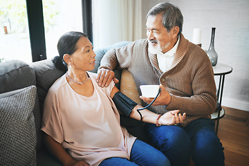 Image showing Hypertension, healthcare and senior couple in living room with equipment for blood pressure. Sick, love and elderly man with medical tool for woman in retirement in the lounge of modern home together