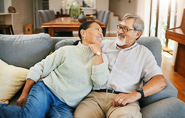 Image showing Smile, happy and senior couple on a sofa bonding, talking and relaxing together in living room. Romance, love and elderly man and woman in retirement in conversation by modern lounge at home.