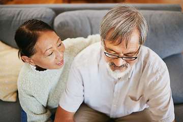 Image showing Conversation, happy and senior couple on a sofa bonding, talking and relaxing together in living room. Smile, love and top view of elderly man and woman in retirement speaking in lounge at home.