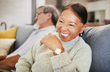 Image showing Mature, woman and laugh on sofa with smile in lounge for joke on holiday, vacation or retirement. Face, elderly couple or asian person for funny, goofy or silly talk and relax with husband in home