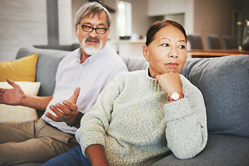 Image showing Divorce, fight and mature couple on sofa, conflict and marriage crisis in home. Asian man, woman and argument in living room, stress and angry at relationship fail, frustrated people together and sad