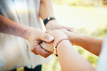 Image showing Holding hands, closeup and couple in park, sunshine and care with bonding, faith or pray in nature. People, trust and support for empathy, romance or comfort in backyard, lawn or outdoor for kindness