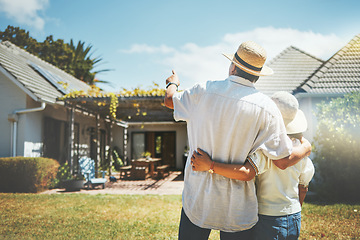 Image showing Back view, couple and pointing outdoor at new home, real estate or house investment. Man, woman and hug at front of property for moving together in building, dream neighborhood and mortgage at garden