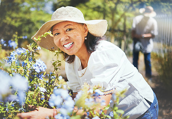 Image showing Portrait, mature and woman for gardening with hat, landscaping and backyard in spring. Asian person, grandmother and love with smile for blue flowers in bloom for peace, relax or wellness for care