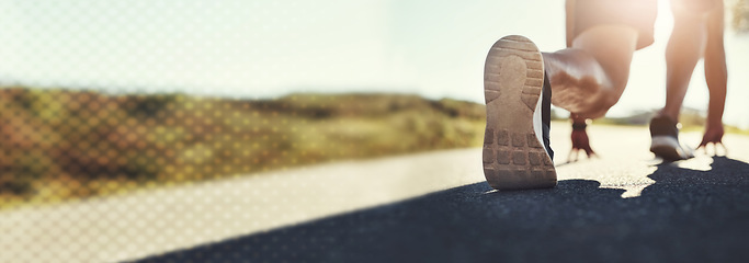 Image showing Man, shoes and banner on road for running, start or fitness in workout, training or outdoor exercise. Closeup of male person legs getting ready for run on asphalt or street in nature or marathon