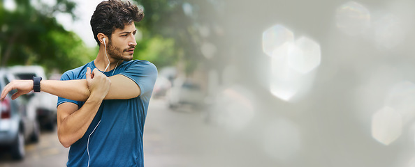 Image showing Fitness, stretching and man in a road with music earphones for training, running or cardio with bokeh. Arm, stretch and male runner in a street for body warm up, workout or exercise with podcast