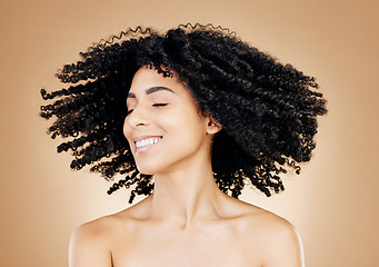 Image showing Woman, curly or hair shake in afro fun on studio background for healthy hairstyle growth, texture or frizz treatment success. African beauty model, energy or change by shampoo transformation results