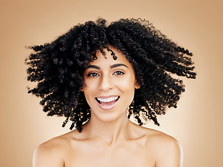 Image showing Model, curly and hair wind in afro fun on studio background for healthy hairstyle growth, texture or frizz treatment. African beauty woman, portrait and shake change by shampoo transformation results