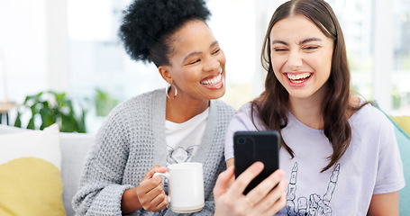 Image showing Coffee, phone and girl friends on a sofa talking, bonding and networking on social media or mobile app. Happy, conversation and young women scroll on cellphone with latte in living room of apartment.