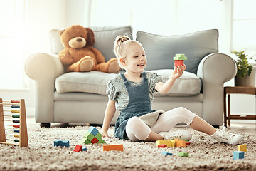 Image showing Child, playing and building blocks on living room floor, home and montessori style for fun, development and game. Colourful toys, learning and creativity for educational activity, relax and happiness