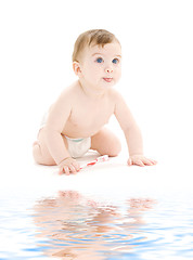 Image showing baby boy in diaper with toothbrush sticking tongue out