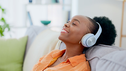 Image showing Calm woman, music and headphones in home for listening to audio, radio and hearing podcast on sofa. Happy african person relax for streaming sound, multimedia and peaceful subscription in living room