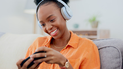 Image showing Smartphone games, headphones or woman in home on sofa for playing online subscription, digital gaming or connection. Happy african person, video game or mobile in living room for streaming multimedia