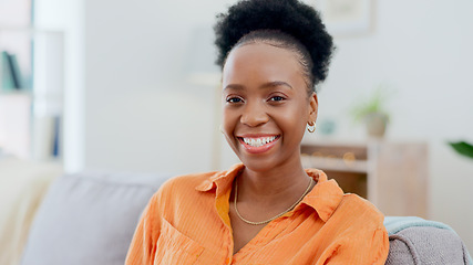 Image showing Portrait, relax and smile with a black woman on a sofa in the living room of her home during the weekend. Face, freedom and afro with a happy young person alone in the lounge of her apartment