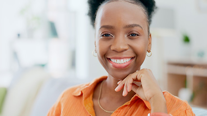 Image showing Portrait, freedom and smile with a black woman on a sofa in the living room of her home during the weekend. Face, relax and happy with a confident young person alone in the lounge of her apartment