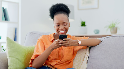 Image showing Smile, black woman and typing on smartphone on sofa, update social media post and mobile chat at home. Cellphone, app and download digital games, reading multimedia connection and online subscription
