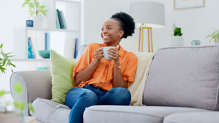 Image showing Black woman, smiling and couch with tea, relaxing and cozy home for self care, living room and break. Me time, comfort and quality time in house, sofa and day off for resting, laughing and happiness