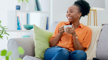Image showing Black woman, house and couch with coffee, relaxing and smiling for self care, living room and break. Me time, comfort and quality time in home, sofa and day off for resting, laughing and happiness