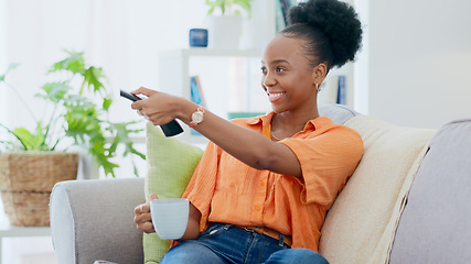 Image showing Woman, coffee and remote of tv on sofa at home to watch subscription, cable show and movies. Happy african person, drinking tea and relax in living room for television, multimedia broadcast and film