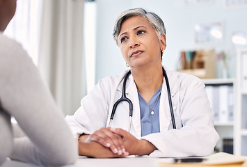 Image showing Medical, holding hands and doctor with woman in clinic for support. empathy or care. Checkup, discussion and closeup of female healthcare worker with sympathy for patient in medicare hospital.