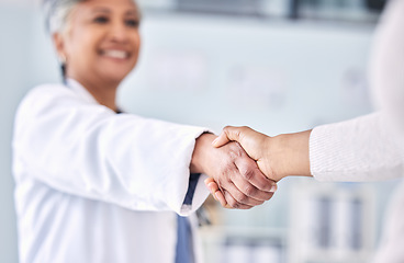 Image showing Doctor, patient and handshake in partnership, meeting or deal for healthcare agreement at hospital. Happy medical professional shaking hands or person in thank you, welcome or introduction at clinic