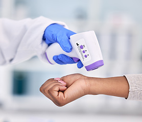 Image showing Doctor, hands and thermometer for patient temperature, fever or checkup appointment at hospital. Closeup of medical nurse or surgeon checking customer with infrared scanner for virus or flu at clinic