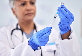 Image showing Hands, doctor with needle and vaccine bottle for health, safety from virus and medicine at clinic. Pharmaceutical drugs, senior woman has container and syringe for immunity, healthcare and wellness